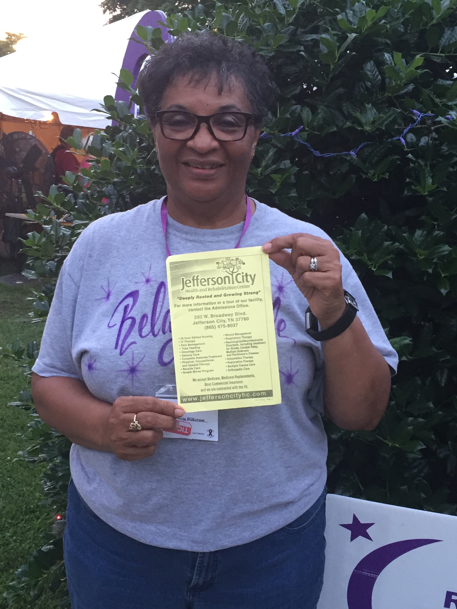 Pat, LPN, holding up Jefferson City's flyer with services and center information